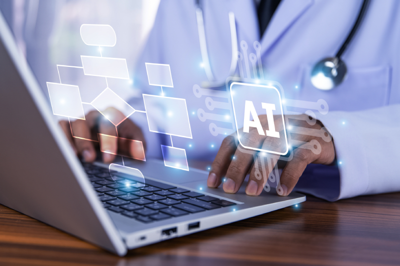 A doctor using laptop with the hologram images of artificial intelligence flow chart for planning patient treatment.