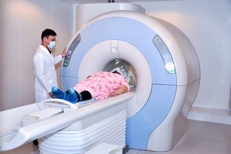 A doctor preparing CT machine for scanning.