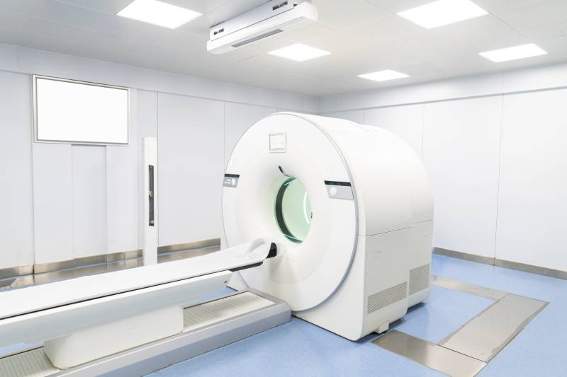 Side view of a PET-CT scanner in a scanning room.