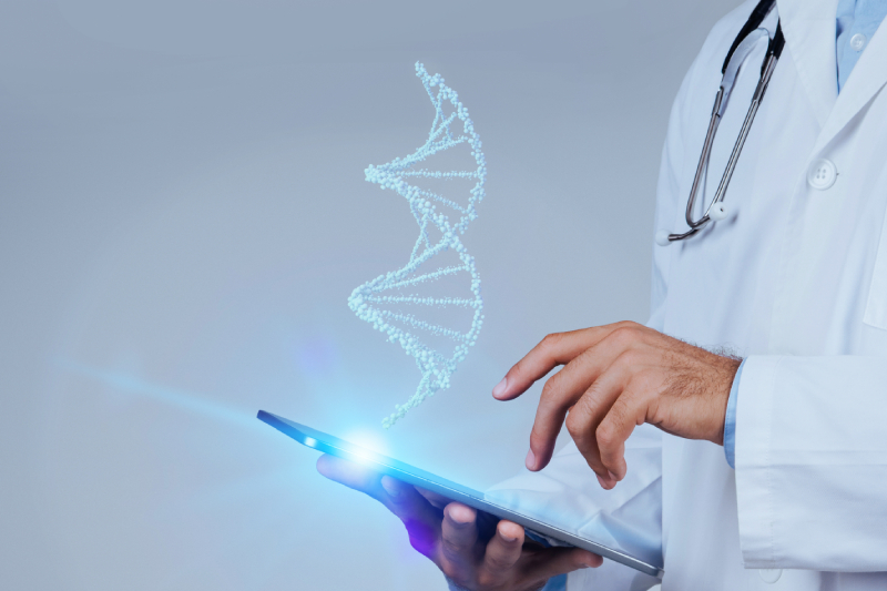 Side view of a doctor using a tab or a mobile and a virtual image of a DNA strand shown above it.