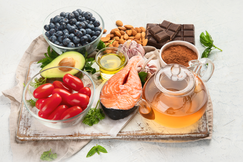 A top view of a tray containing high antioxidant rich foods placed on a white table.