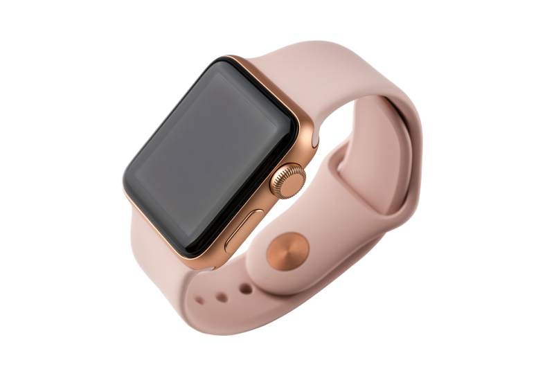 Image of a pink strapped apple smart watch with a copper and black dial displayed on a white background.