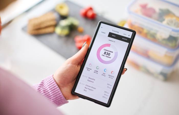 A woman checks the calories of food consumed using a mobile app