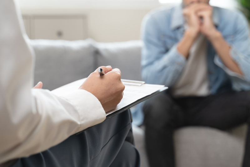 A counselor provides counseling to an anxiety patient and giving guidance on mental therapy care to improve mental health.